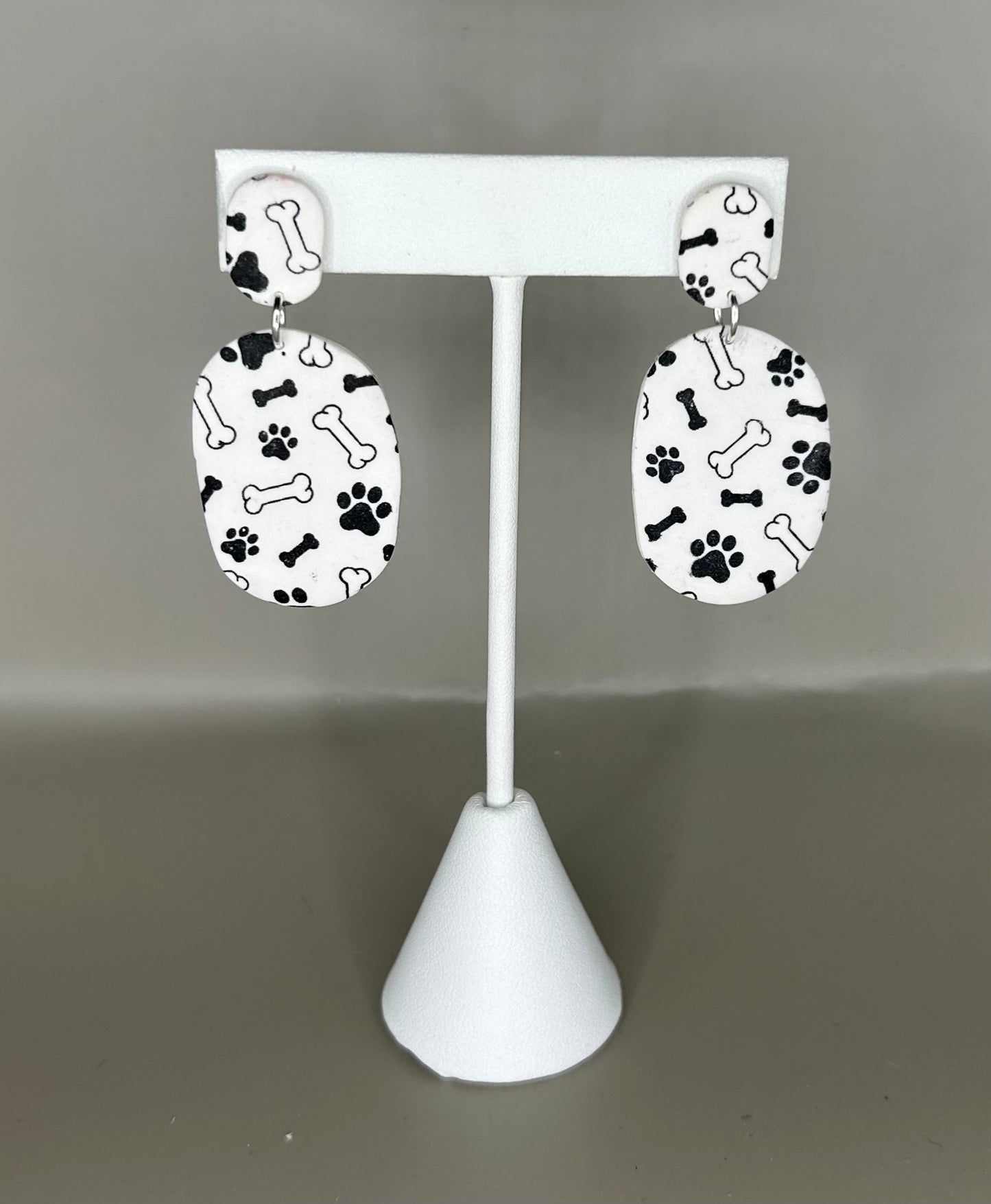 Paw print and bone oval earring